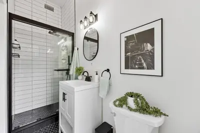 a bathroom with a toilet and a sink and a mirror at 2BR and 2BA in Historic Brownstone near Subway in New York