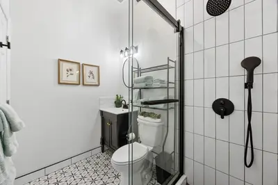 a bathroom with a toilet and a shower at 2BR and 2BA in Historic Brownstone near Subway in New York