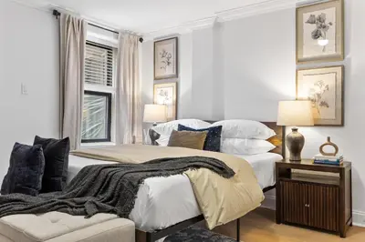 a bedroom with two beds and a couch at Brownstone 2 Bed with Private Backyard near Subway in New York