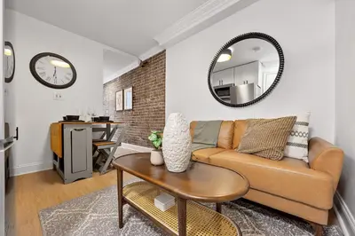 a living room with a couch and a table at Brownstone 2 Bed with Private Backyard near Subway in New York