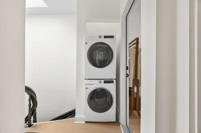 a washer and dryer in a room with a mirror at 3BR Harlem Stay with Washer with Dryer in New York