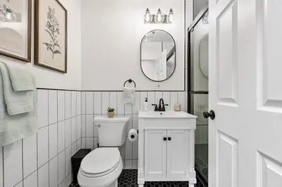 a bathroom with a toilet and a sink and a mirror at 3BR Harlem Stay with Washer with Dryer in New York