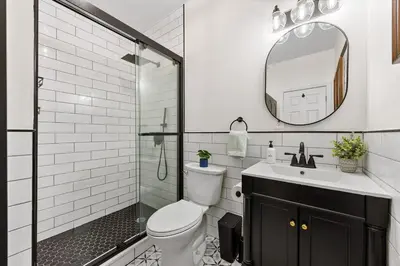 a bathroom with a shower and a toilet and a sink at 3BR Harlem Stay with Washer with Dryer in New York