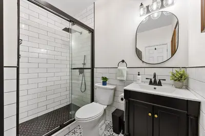 a bathroom with a shower and a toilet and a sink at 3BR Harlem Stay with Washer with Dryer in New York