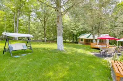 a yard with a picnic table and a tent at Screened Porch and Fire Pit Cabin Near Bethel Woods in Mongaup Valley