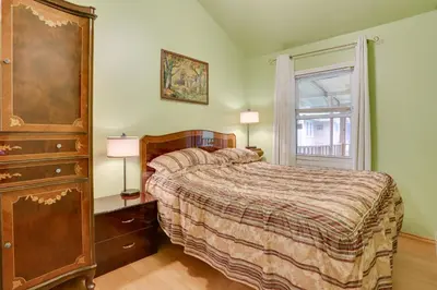 a bedroom with a bed with a dresser and a window at Screened Porch and Fire Pit Cabin Near Bethel Woods in Mongaup Valley