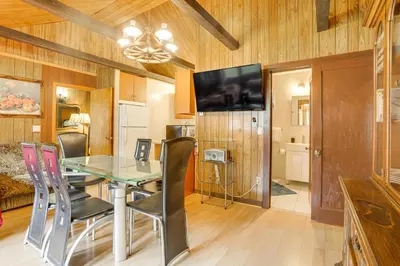 a dining room with a glass table and chairs at Community Perks Mongaup Valley Cabin with Grill! in Mongaup Valley