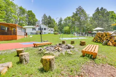 a park with benches and a fire pit and a playground at Community Perks Mongaup Valley Cabin with Grill! in Mongaup Valley