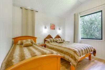 two beds in a bedroom with a window at 6 Mi to State Park Mongaup Valley Cabin! in Mongaup Valley