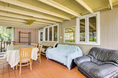 a living room with a couch and a table at 5 Mi to Monticello Raceway Cabin Near Shops in Mongaup Valley