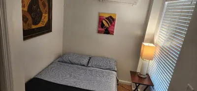 a small bedroom with a small bed in a room at Garden Apartment in New York