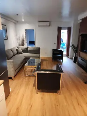 a living room with a couch and a table at Garden Apartment in New York