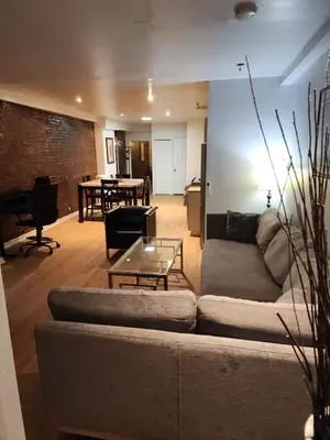 a living room with a couch and a table at Garden Apartment in New York