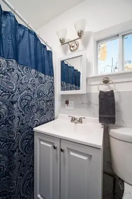 a bathroom with a sink and a toilet at Whole House Near NYC and Transit with Game Room Fire Pit and King Bed in New Rochelle