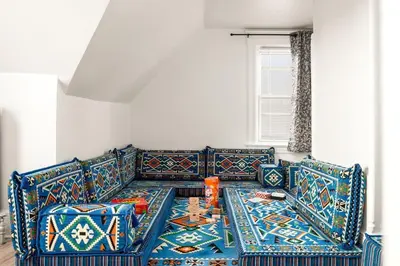 a living room with a couch and a table at Whole House Near NYC and Transit with Game Room Fire Pit and King Bed in New Rochelle