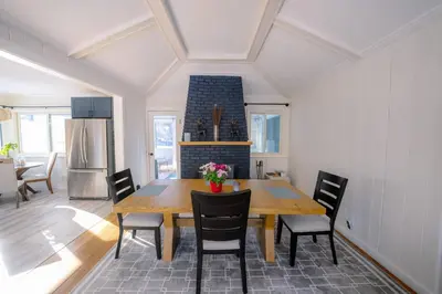 a kitchen and dining room with a wooden table and chairs at Oscawana Lake Escape in Putnam Valley