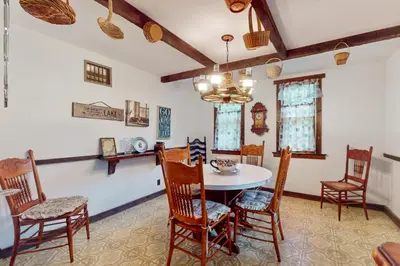 a dining room with a table and chairs at Adirondacks in Style! Lake House with Deck, Fire Pit in Hadley