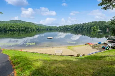 a view of a lake with a sandy beach at Adirondacks in Style! Lake House with Deck, Fire Pit in Hadley