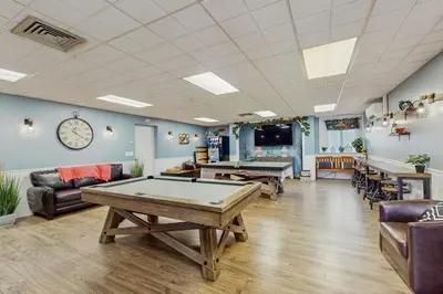 a pool table in a room with couches and tables at Lounging in Long Pond in Long Pond