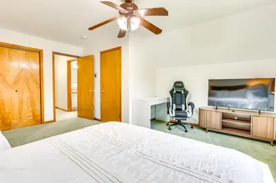 a bedroom with a bed and a desk and a fan at Home Theater and Game Room Home in Glen Wild! in Glen Wild