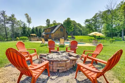 a group of chairs sitting around a fire pit at Home Theater and Game Room Home in Glen Wild! in Glen Wild