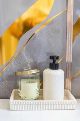 a bottle of soap and a candle on a shelf at Modern Studio - Parking Available - 15 min NYC in Jersey City