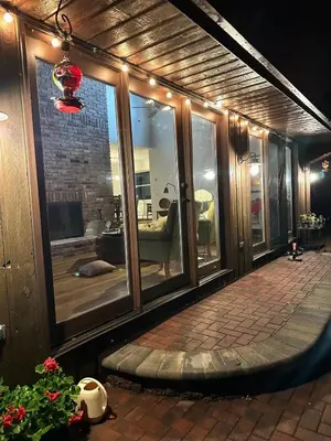 a room with glass windows and a room with a couch at Nature's Nest - Woodland Retreat - Fireplace - Quiet and Cozy in Bethlehem