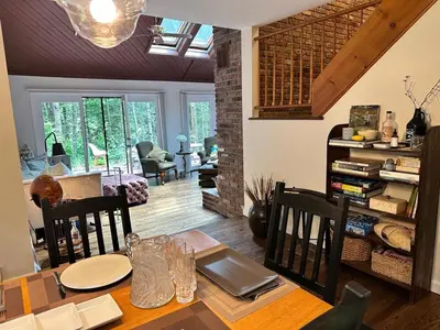 a dining room with a table with chairs and a dining room at Nature's Nest - Woodland Retreat - Fireplace - Quiet and Cozy in Bethlehem