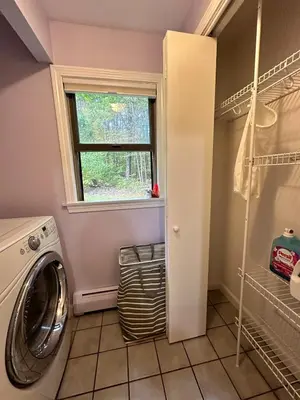 a laundry room with a washing machine and a window at Nature's Nest - Woodland Retreat - Fireplace - Quiet and Cozy in Bethlehem