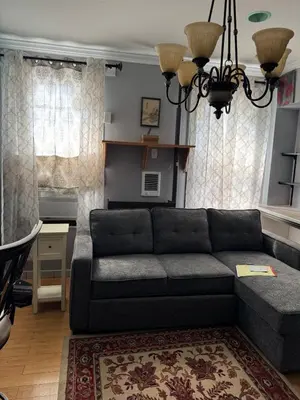 a living room with a couch and a table at Classic king and queen suite in Schenectady