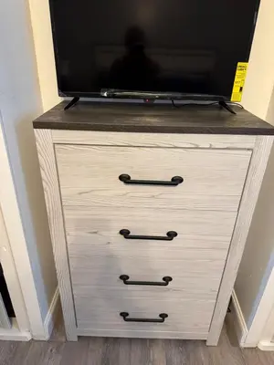 a dresser with a tv on top of it at Classic king and queen suite in Schenectady