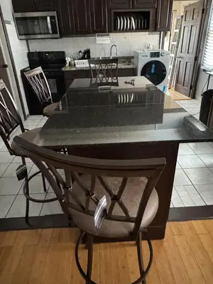 a kitchen with a black counter top in a room at Classic king and queen suite in Schenectady