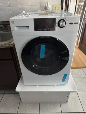 a white washing machine sitting on top of a counter at Classic king and queen suite in Schenectady