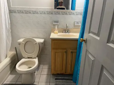 a bathroom with a toilet and a sink at Peculiar 153 in Newark