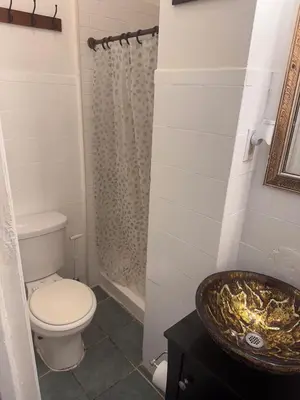 a bathroom with a toilet and a sink at Kitchenette in New York