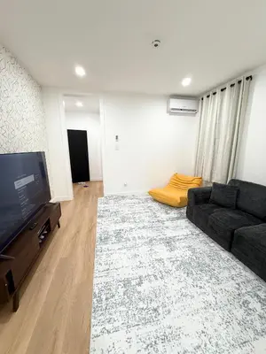 a living room with a couch and a flat screen tv at The View - Direct Bus Time Square NYC Breakfast Included - A in Jersey City