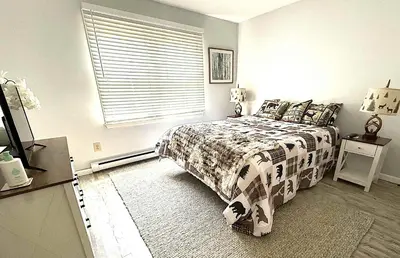 a bedroom with a bed and a window at 2 BR JIMINY PEAK w Mountain Views SLEEPS 7 Gorgeous in Hancock