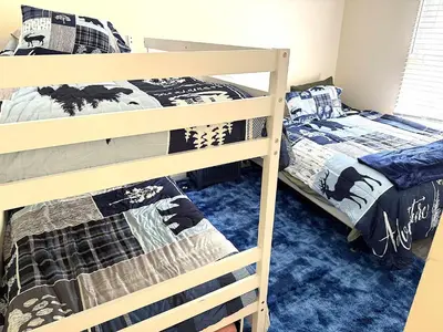 a bedroom with two bunk beds and a small bed at 2 BR JIMINY PEAK w Mountain Views SLEEPS 7 Gorgeous in Hancock