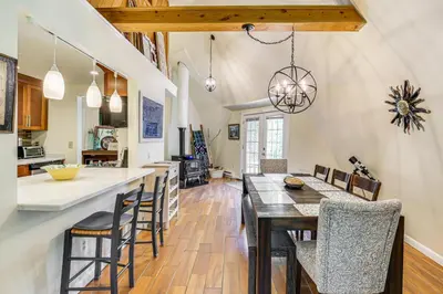 a kitchen and dining room with a table and chairs at Ski, Snowshoe and Fish Dome Escape in Nature! in Warren