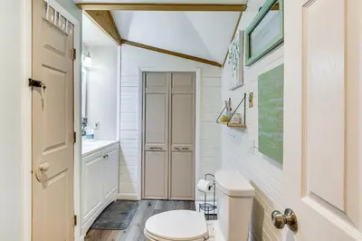 a bathroom with a toilet and a sink at Ski, Snowshoe and Fish Dome Escape in Nature! in Warren