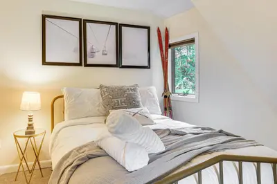 a bedroom with a bed with pillows and a window at Ski, Snowshoe and Fish Dome Escape in Nature! in Warren