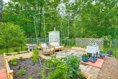 a garden with a swing and some plants at Ski, Snowshoe and Fish Dome Escape in Nature! in Warren