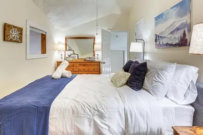 a bedroom with a large white bed with pillows at Ski, Snowshoe and Fish Dome Escape in Nature! in Warren