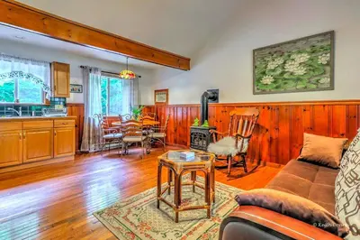 a living room with a couch and a table at Charming Forest Cabin with a Hammock near Delaware Water Gap National Recreation Area, Pennsylvania in Canadensis