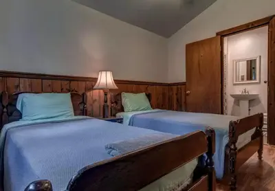 a bedroom with two beds and a lamp and a sink at Cozy Cottage Rental with Small Private Pond in Canadensis, Pennsylvania in Canadensis