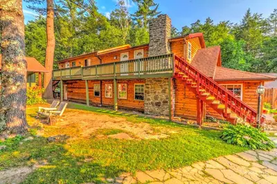 a large log house with a staircase on it at Cozy and Secluded Cabin with a Fireplace in the Poconos Mountains of Pennsylvania in Canadensis