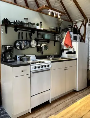 a kitchen with a white stove and a white refrigerator at Incredible Equipped Yurt Amazing for a Glamping Experience in East Meredith, New York in East Meredith