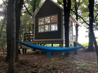 a hammock in front of a tiny house at Romantic New York Getaway near the Adirondacks in Cambridge