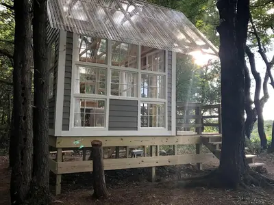 a tree house on a bench in the woods at Romantic New York Getaway near the Adirondacks in Cambridge