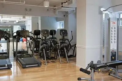 a gym with a bunch of exercise equipment in a room at Blueground Manhattan Valley fitness nr Central Park NYC-1101 in New York
